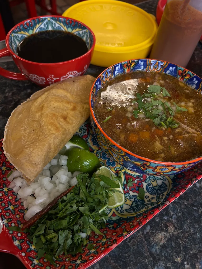 Mexican soup with onion, cilantro and lime
