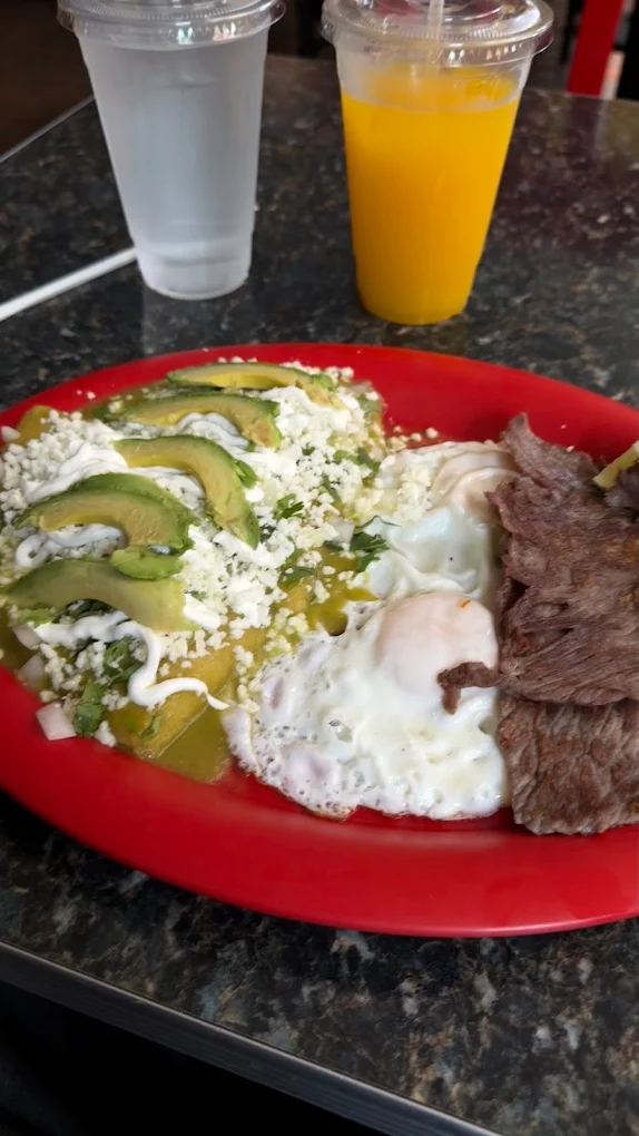 Plate with green salsa, avocado, eggs and steak